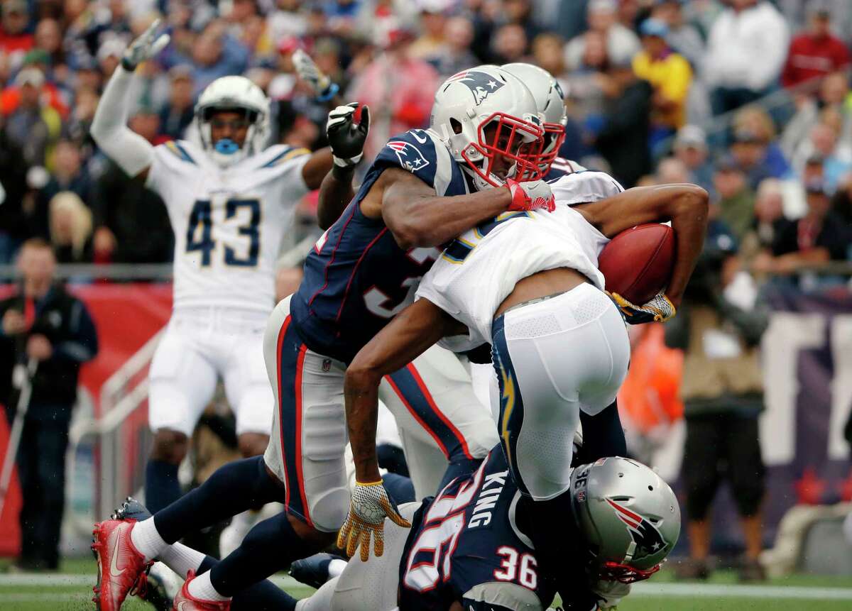 New England Patriots' Jonathan Jones top and Brandon King (36) tackle Los Angeles Chargers punt returner Travis Benjamin (12) in the end zone for a safety during the first half of an NFL football game, Sunday, Oct. 29, 2017, in Foxborough, Mass. (AP Photo/Michael Dwyer) ORG XMIT: FBO108