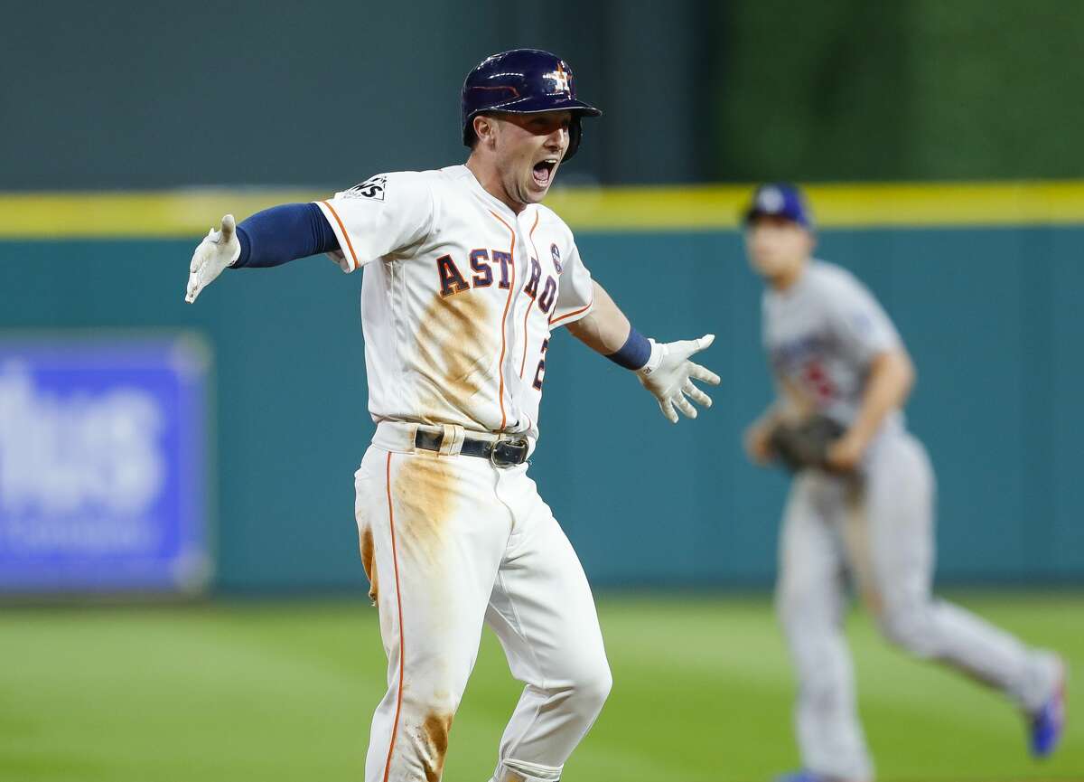 Houston Astros third baseman Alex Bregman (2) celebrates his walk off single that drove in left fielder Derek Fisher (21) to give the Astros a 13-12 victory over the Los Angeles Dodgers in the tenth inning of Game 5 of the World Series at Minute Maid Park on Monday, Oct. 30, 2017, in Houston.