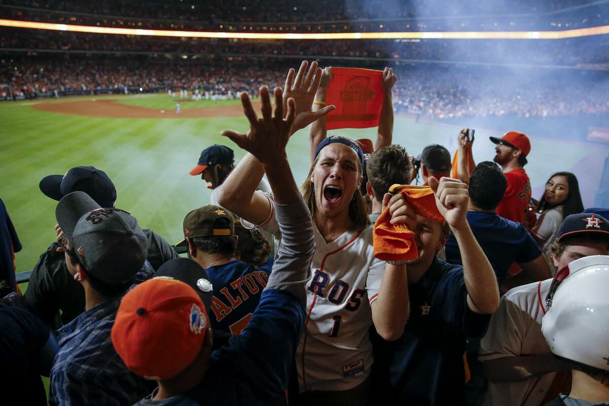 Fans celebrate after the tenth inning as the Houston Astros beat the Los Angeles Dodgers 13-12 in Game 5 of the World Series at Minute Maid Park Monday, Oct. 30, 2017 in Houston.