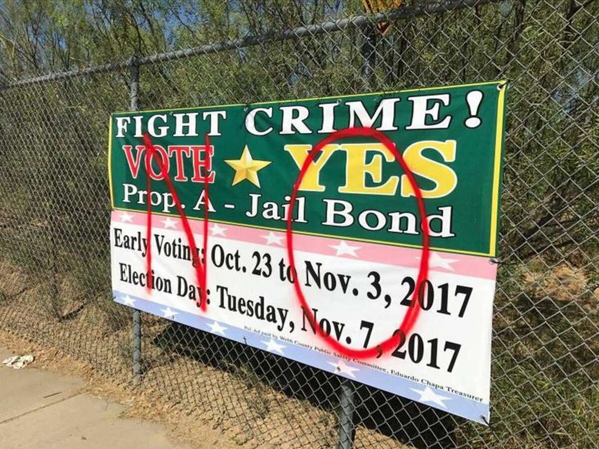 A poster promoting the vote for the approval of a bonus of 125 million dollars for the construction of a new prison appears vandalized with the word NO.