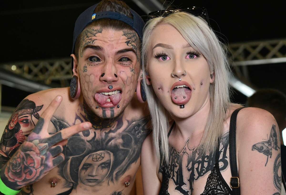 A couple show off their body art at the Rites of Passage tattoo festival event in Sydney on October 29, 2017. The annual Rites of Passage tattoo festival attracts more than 250 local and international tattoo artists to Australia. / AFP PHOTO / PETER PARKS (Photo credit should read PETER PARKS/AFP/Getty Images)