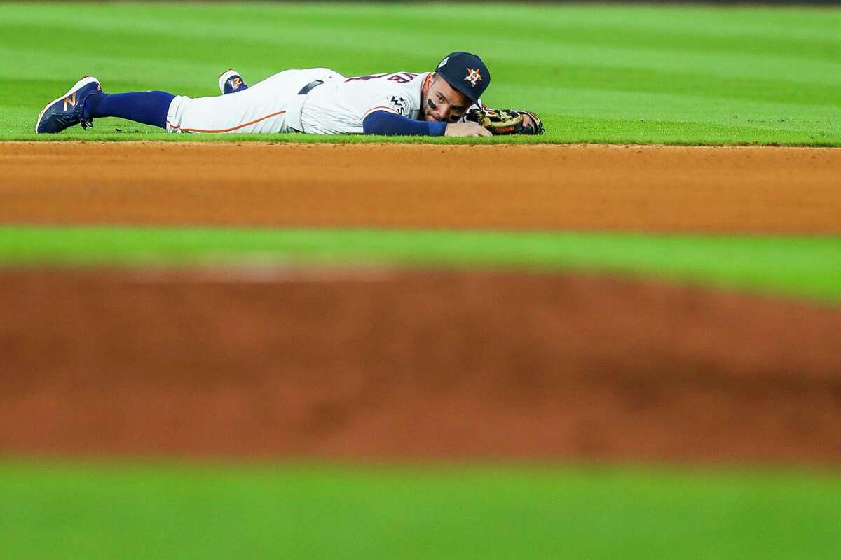 Houston Astros second baseman Jose Altuve (27) reacts after failing to throw Los Angeles Dodgers second baseman Charlie Culberson (37) out at first after a single in the fourth inning of Game 5 of the World Series at Minute Maid Park on Sunday, Oct. 29, 2017, in Houston.