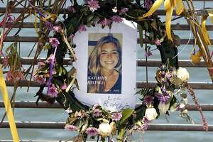 FILE - This July 17, 2015, file photo shows flowers and a portrait of Kate Steinle displayed at a memorial site on Pier 14 in San Francisco, Calif. The bullet that killed Kate Steinle two years ago ricocheted off the ground about 100 yards away before hitting her in the back and later launching a criminal case at the center of a national immigration debate. A San Francisco police officer who helped supervise the investigation testified about the bullet’s trajectory Monday, Oct. 30, 2017 at Zarate's trial. (Paul Chinn /San Francisco Chronicle via AP, File)