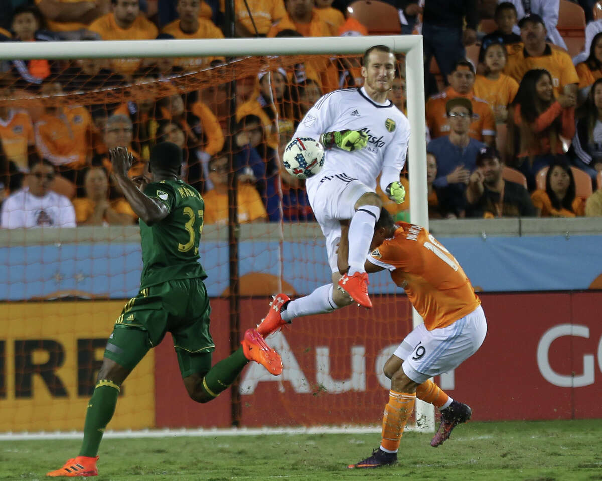 Portland Timbers goalkeeper Jeff Attinella (1) collides with Houston Dynamo forward Mauro Manotas (19) as he comes out to get the ball away from Manotas during the MLS Western Conference semifinal soccer match Monday, Oct. 30, 2017, in Houston. (Yi-Chin Lee/Houston Chronicle via AP)