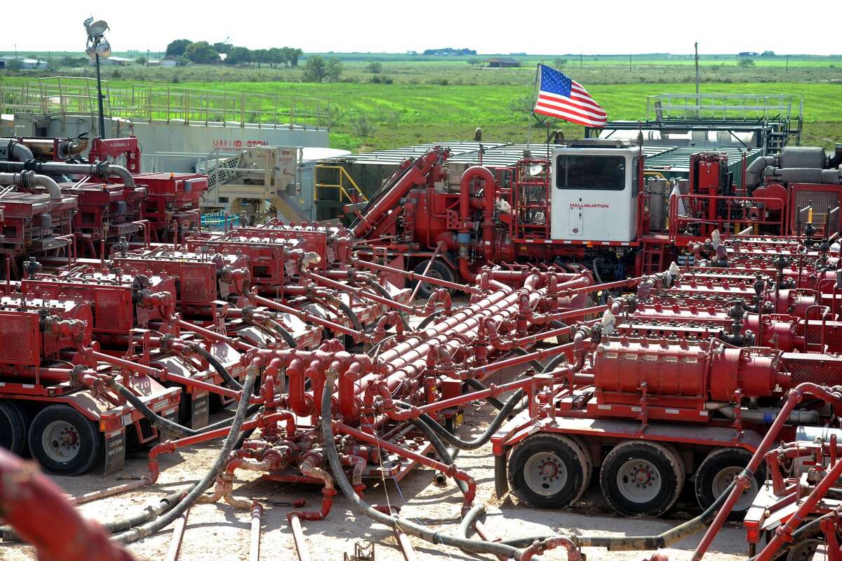 A series of Halliburton pumping units provide pressure to a wellhead on a fracking site managed by Octane Energy near Stanton. 
