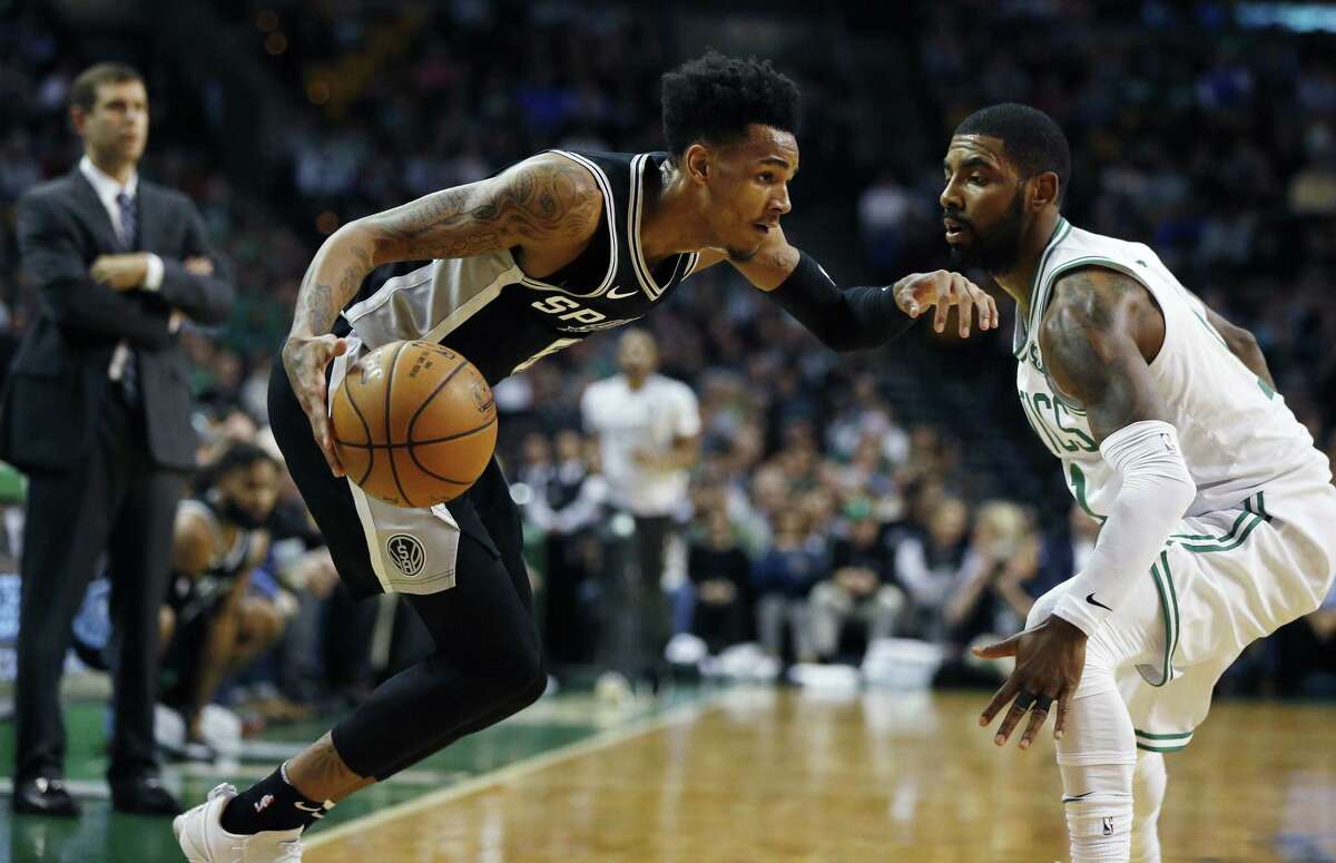 San Antonio Spurs' Dejounte Murray drives past Boston Celtics' Kyrie Irving during a game in Boston on Oct. 30.
