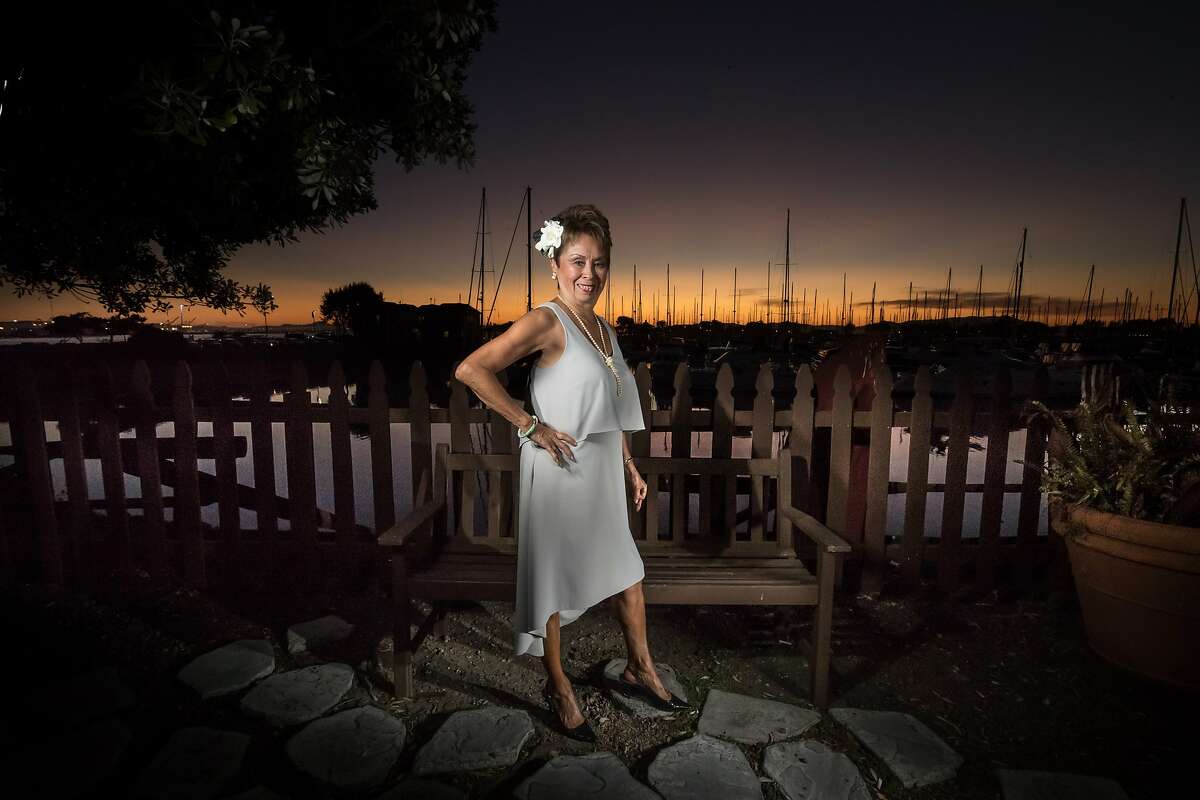 Retiring Claudette Lum, a hostess for Trader Vic's since 1960, pose outside the restaurant on Friday, Oct. 6, 2017 in Emeryville, CA.