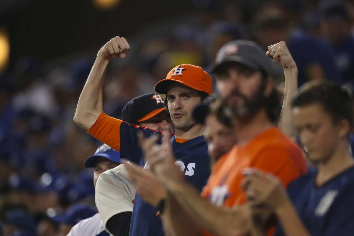 Astros fans react to George Springer's two-run home run in the eleventh inning of Game 2 of the World Series at Dodger Stadium on Wednesday, Oct. 25, 2017, in Los Angeles.
