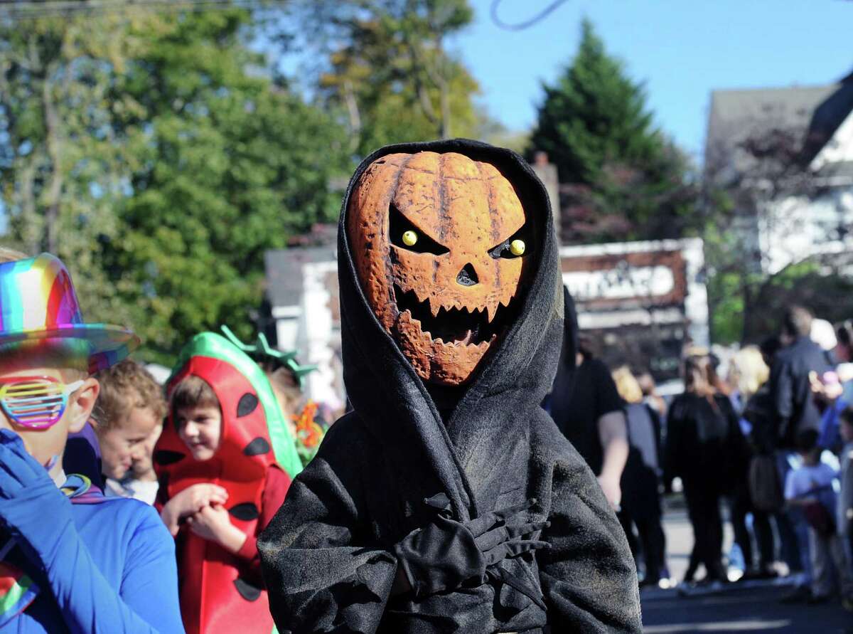 Old Greenwich School third-grader Linden Bechtel wore a Jack-O'-Lantern costume while marching in the Halloween parade at the school and down Sound Beach Avenue in Old Greenwich, Conn., Tuesday, Oct. 31, 2017.