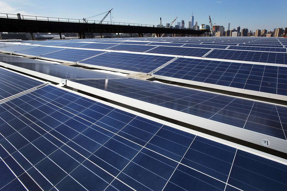 FILE - In this Feb. 14, 2017, file photo, a rooftop is covered with solar panels at the Brooklyn Navy Yard, Tuesday, Feb. 14, 2017, in New York. A U.S. trade commission is recommending that the Trump administration impose tariffs of up to 35 percent to slow an influx of low-cost solar panels imported from China and other countries. (AP Photo/Mark Lennihan, File)