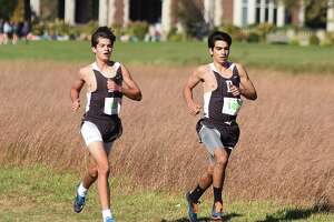 Brunswick runners Kyle Raker, left, and Andres Jasson race at Waveny Park in New Canaan on Tuesday during the FAA boys varsity cross country championship race.