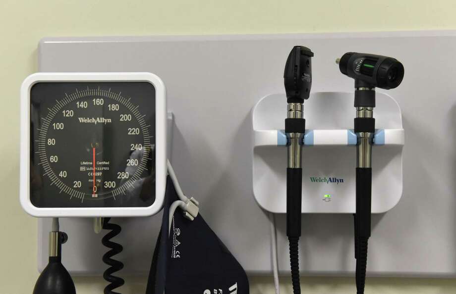 A blood pressure monitor and ear examination tools are mounted to an examination room wall in the health clinic at Mont Pleasant Middle School on Friday, June 9, 2017, in Schenectady, N.Y. (Will Waldron/Times Union) Photo: Will Waldron / 40040735A