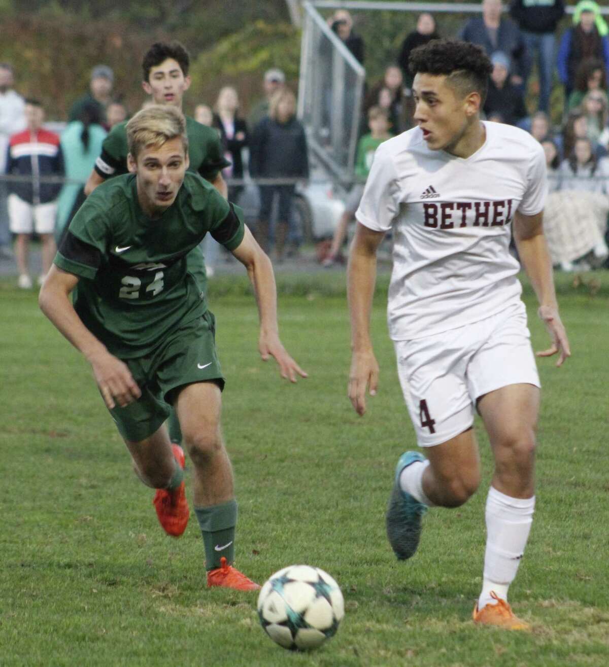 Bethel’s Gabriel Carrijo, right, looks for an opening as New Milford’s Chase Schuster defends during the South-West Conference quarterfinal boys soccer game at Rourke Field in Bethel on Oct. 27.