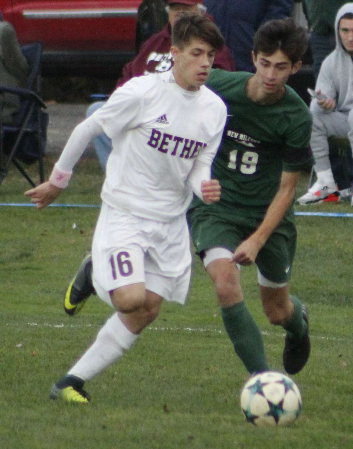 Bethel's Bryan Osebio, left, dribbles the ball upfield as New Milford's Erik Byrnes defends during the South-West Conference quarterfinal boys soccer game at Rourke Field in Bethel Oct. 27, 2017.