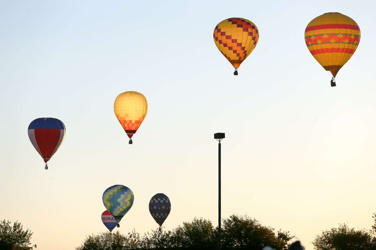 Hot air balloons chase the RE/MAX "Hare" balloon in the Hare and Hound chase in the Balloonist competition during the Skylight Balloon Fest on the River City Community Church Grounds, 16765 Lookout Road in Selma, on Sunday, Oct. 29, the final day of the three-day event.
