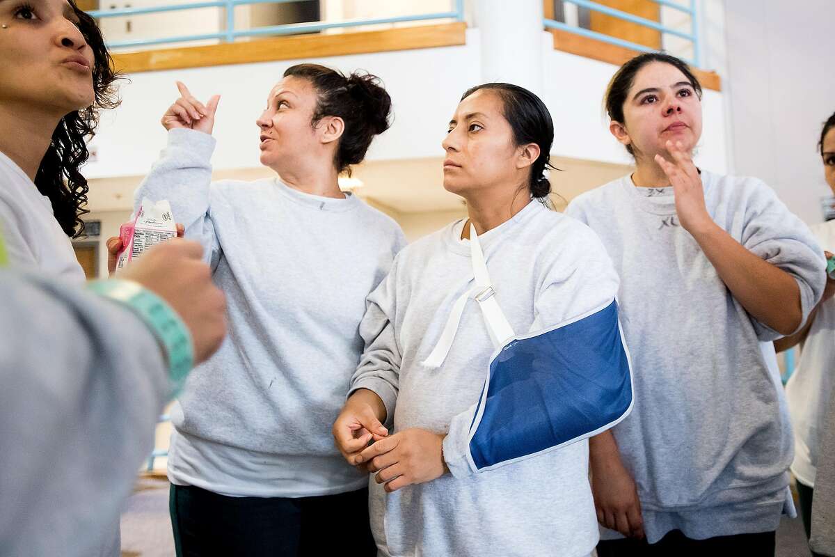 Ana Henriquez, center, and fellow Immigration and Customs Enforcement (ICE) detainees gather at the West County Detention Facility in Richmond, Calif., on Tuesday, Oct. 31, 2017.