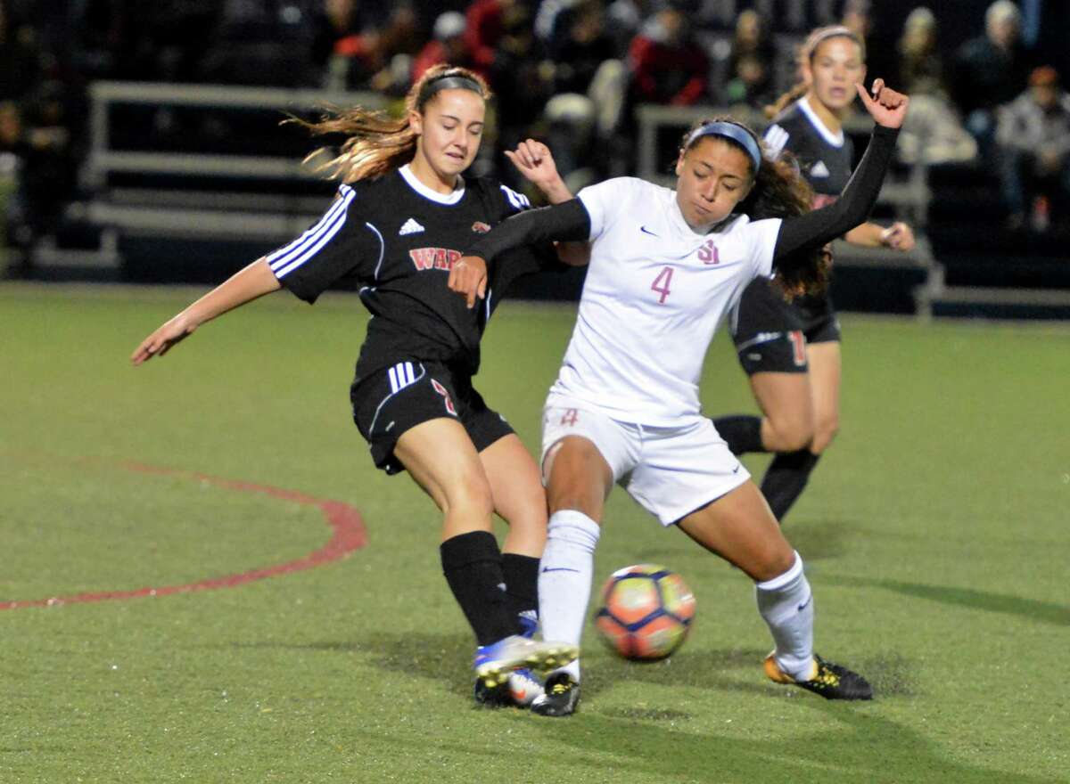 St Joseph's #4 Jessica Mazzo controls moves the ball past Fairfield Warde defenders during FCIAC girls semifinal soccer action at Wilton High School on Wednesday November 1, 2017 in Wilton Conn.