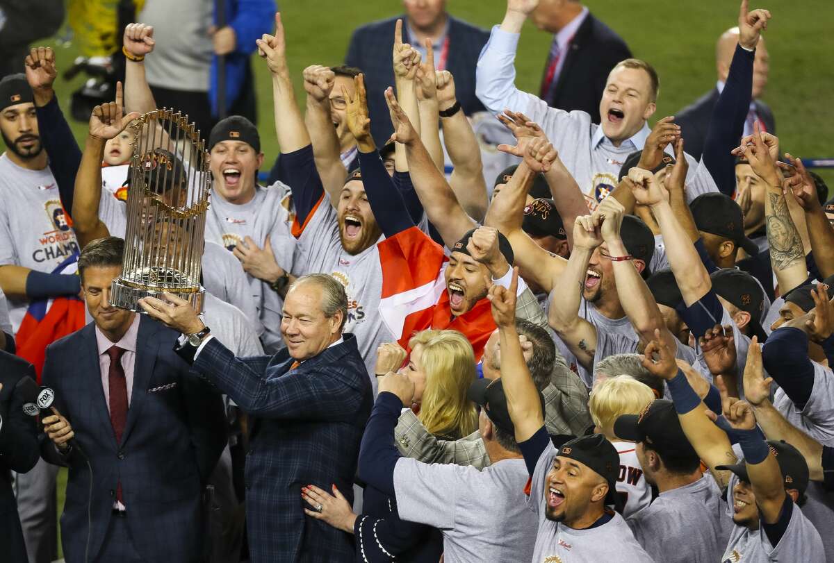 The Houston Astros celebrate as owner Jim Crane holds up the World Series trophy after Game 7 of the World Series at Dodger Stadium on Wednesday, Nov. 1, 2017, in Los Angeles.