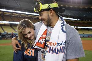 Daniella Rodriguez, former Miss Texas, talks to Houston Astros' Carlos Correa after Game 7 of baseball's World Series Wednesday, Nov. 1, 2017, in Los Angeles. The Astros won 5-1 to win the series 4-3. Correa proposed to Rodriguez after the game. (AP Photo/Jae C. Hong)