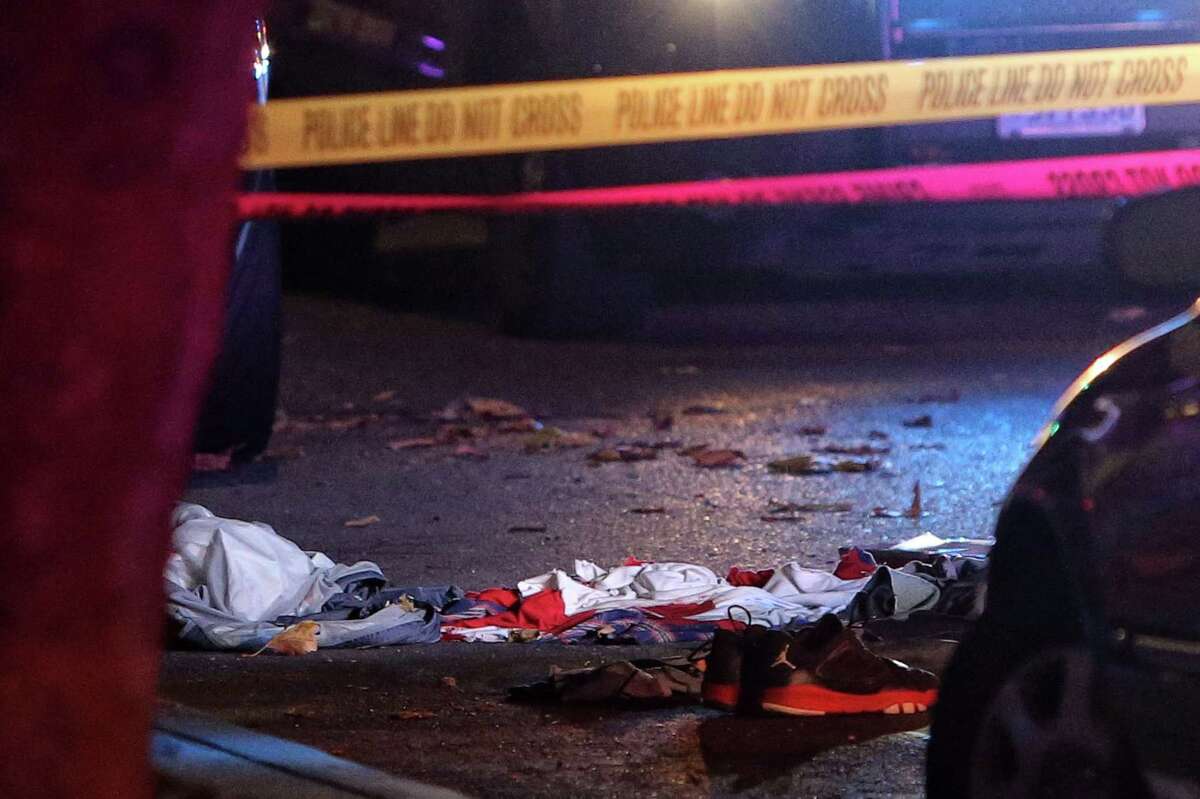 Shoes and clothing are seen as police investigate the scene of a shooting at 5th and Battery Street that occurred just after midnight, Thursday, Nov. 2, 2017. Two of the three victims were killed and the third was taken to Harborview Medical Center for treatment of his injuries.Prosecutors say one of the two men involved in the shooting was nabbed near the Mexican border in San Diego.