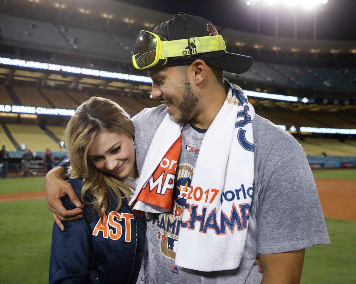 Daniella Rodriguez, former Miss Texas, talks to Houston Astros' Carlos Correa after Game 7 of baseball's World Series Wednesday, Nov. 1, 2017, in Los Angeles. The Astros won 5-1 to win the series 4-3. Correa proposed to Rodriguez after the game. (AP Photo/Jae C. Hong)