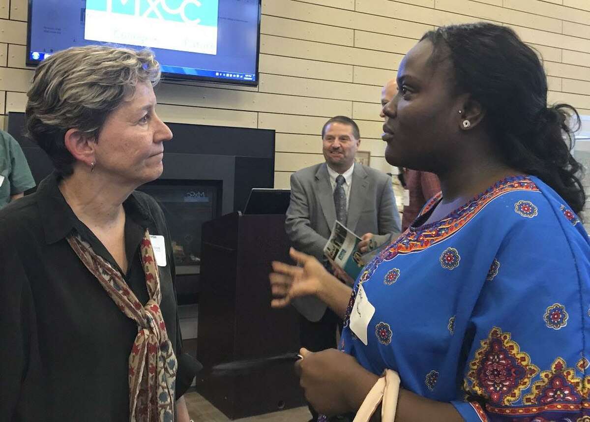 Robin Gilmartin of West Hartford, left, who received a Middlesex Community College Foundation donor recognition award recently, talks to Evelyn Mireku of Meriden, right, who received funding in the past.