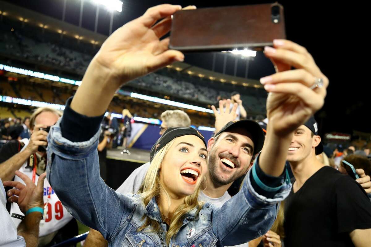 Justin Verlander #35 of the Houston Astros takes a picture with fiancee Kate Upton after the Astros defeated the Los Angeles Dodgers 5-1 in game seven to win the 2017 World Series at Dodger Stadium on November 1, 2017 in Los Angeles, California.
