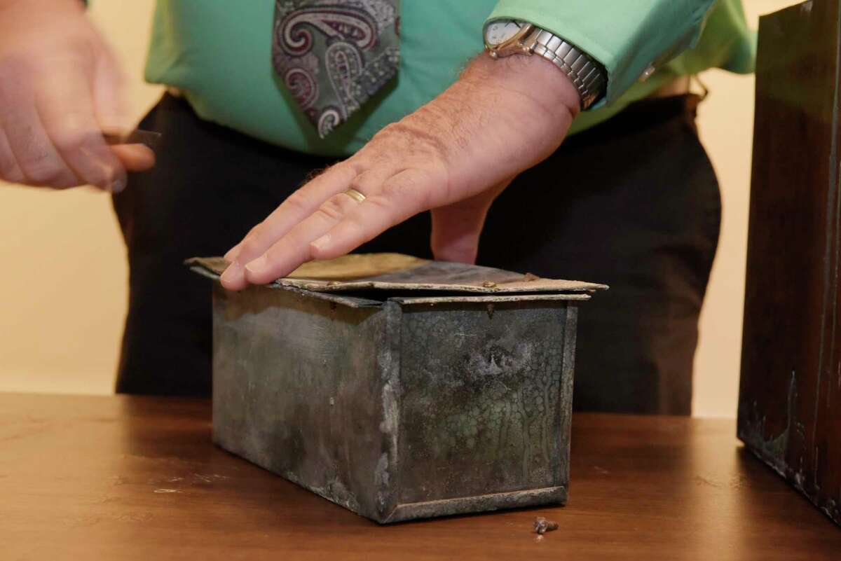 Tim Haskins, project manager with United Group of Companies, removes screws from a copper time capsule box at the Rensselaer County Historical Society on Thursday, Nov. 2, 2017, in Troy, N.Y. The time capsule was in a stone in a building that was the former Immaculate Conception seminary. The College Suites at Hudson Valley was built on the site. (Paul Buckowski / Times Union)