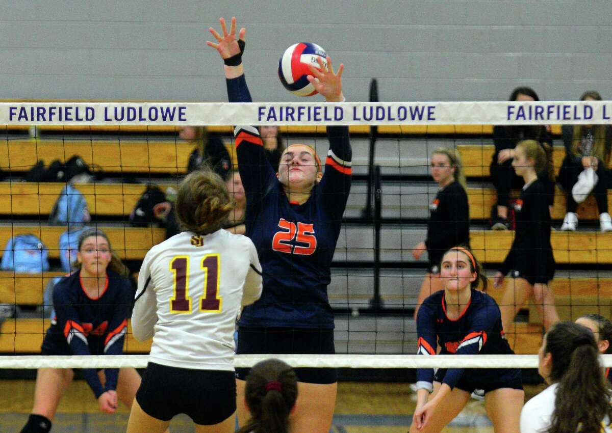 Danbury's Celyna Custodio (25) fails to stop a spike by St. Joseph's Jenna Koonitsky (11) during FCIAC girls volleyball semifinal action in Fairfield, Conn., on Thursday Nov. 2, 2017.