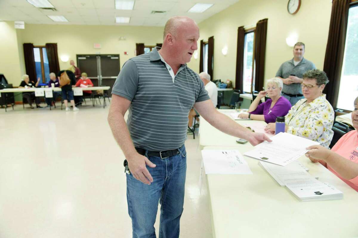 Milton Supervisor candidate Scott Ostrander receives his ballot as he votes at the Milton Community Center on Tuesday, Sept. 12, 2017, in Milton, N.Y. (Paul Buckowski / Times Union)