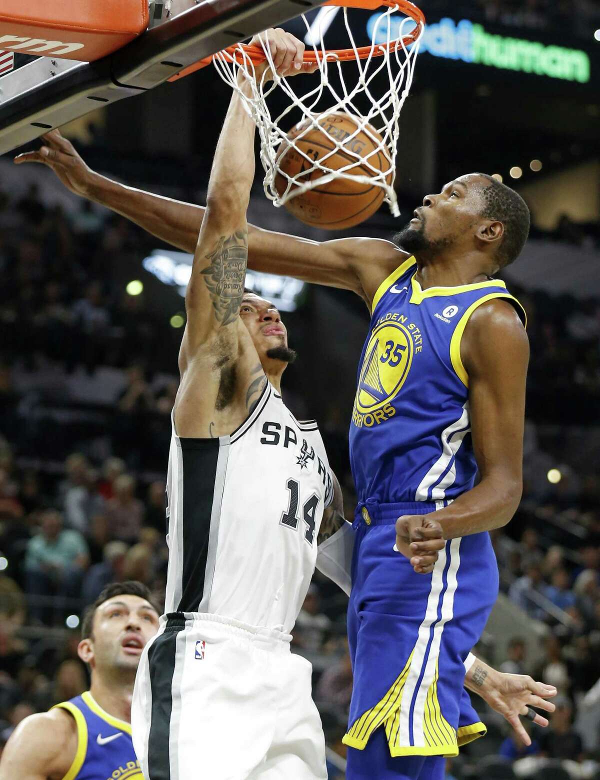 San Antonio SpursÕ Danny Green dunks around Golden State Warriors' Kevin Durant during first half action Thursday Nov. 2, 2017 at the AT&T Center.