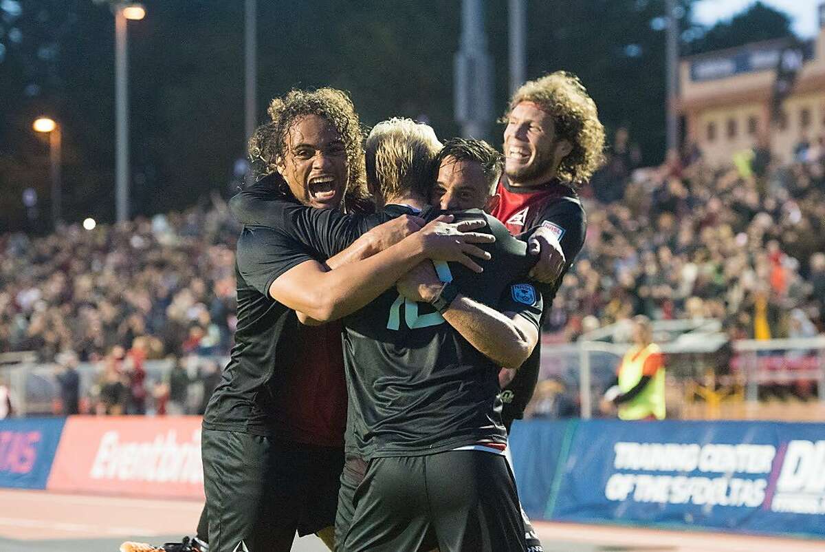 Teammates embrace Kyle Bekker (back to camera) after scoring the first goal in San Francisco Deltas history against the Indy Eleven on March 25, 2017 at Kezar Stadium in San Francisco. (Trevor Will)