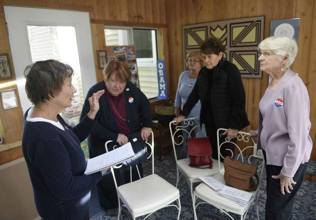 Joan Krantz, left, leads a meeting with Women on Watch (WOW) members during a meeting at member at her home in Stamford, Conn. Monday, Oct. 30, 2017. Women on Watch is a grassroots political initiative promoting awareness, advocacy and action relating to key local and national issues.