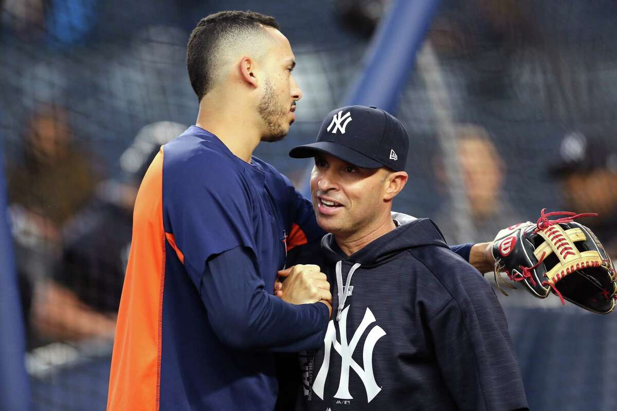 NEW YORK, NY - OCTOBER 16: Carlos Correa #1 of the Houston Astros hugs Joe Espada #53 of the New York Yankees before Game Three of the American League Championship Series at Yankee Stadium on October 16, 2017 in the Bronx borough of New York City.