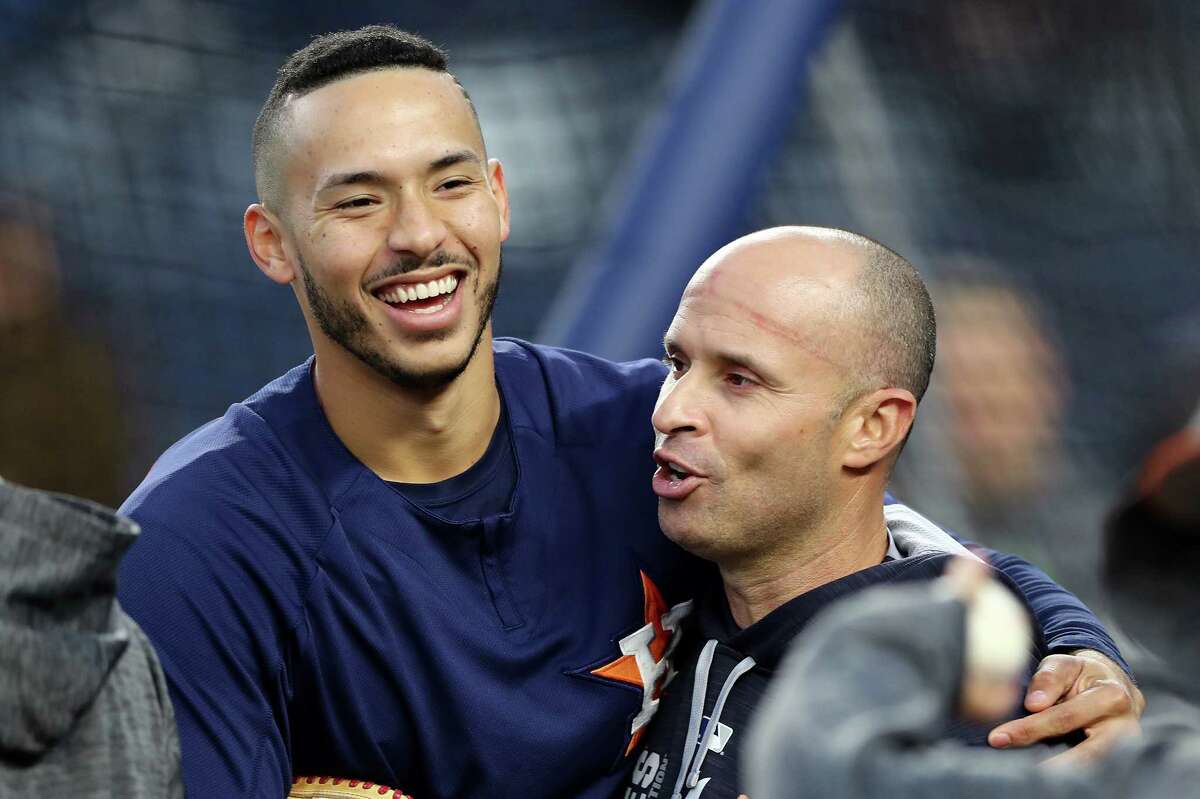 NEW YORK, NY - OCTOBER 16: Carlos Correa #1 of the Houston Astros hugs Joe Espada #53 of the New York Yankees before Game Three of the American League Championship Series at Yankee Stadium on October 16, 2017 in the Bronx borough of New York City.