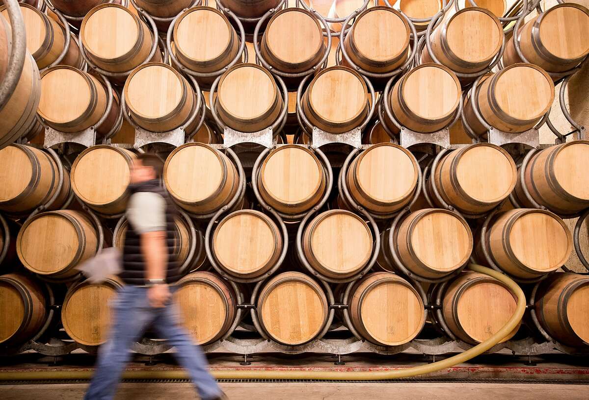 A worker passes barrels at Grgich Hills Estate on Friday, Oct. 6, 2017, in Rutherford, Calif. The vineyard's production techniques, which don't rely on egg whites or fish bladders, make all of its wines vegan.
