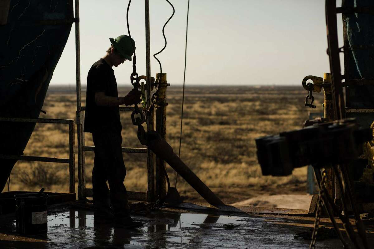 A 2014 photo shows a worker waiting to connect a drill bit on Endeavor Energy Resources's Big Dog Drilling Rig 22 in the Permian basin outside of Midland, Texas. MUST CREDIT: Bloomberg photo by Brittany Sowacke.