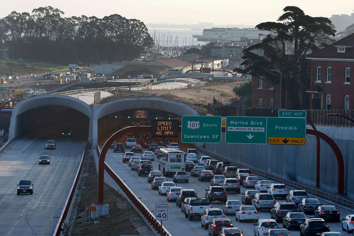 Commuters drive below construction work continuing on the Presidio Tunnel Tops landscaping project in San Francisco, Calif. on Wednesday, Nov. 1, 2017. When completed, the landscaping will completely cover the Presidio Parkway tunnels and bridge the gap between the main post and Crissy Field.