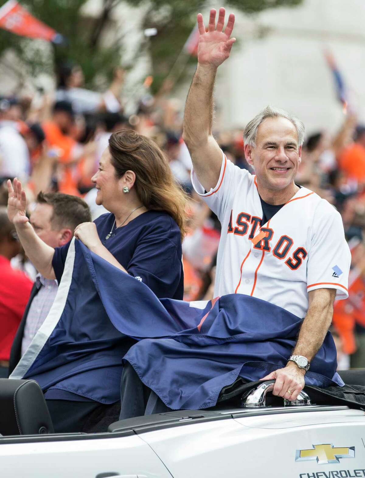 Gov. Greg Abbott waves to the crowd during the Astros World Series championship celebration parade on Friday, Nov. 3, 2017, in Houston.