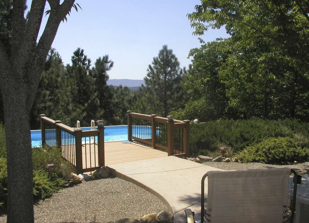 The deck and pool at Mark and Susan Bowe’s Calaveras County home commanded a serene mountain view.