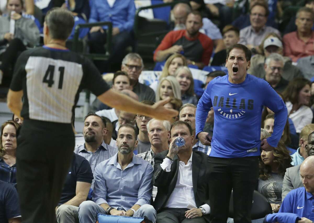 Dallas Mavericks owner Mark Cuban, right, yells at referee Ken Mauer (41) during the first half of an NBA basketball game against the Atlanta Hawks in Dallas, Wednesday, Oct. 18, 2017. (AP Photo/LM Otero)