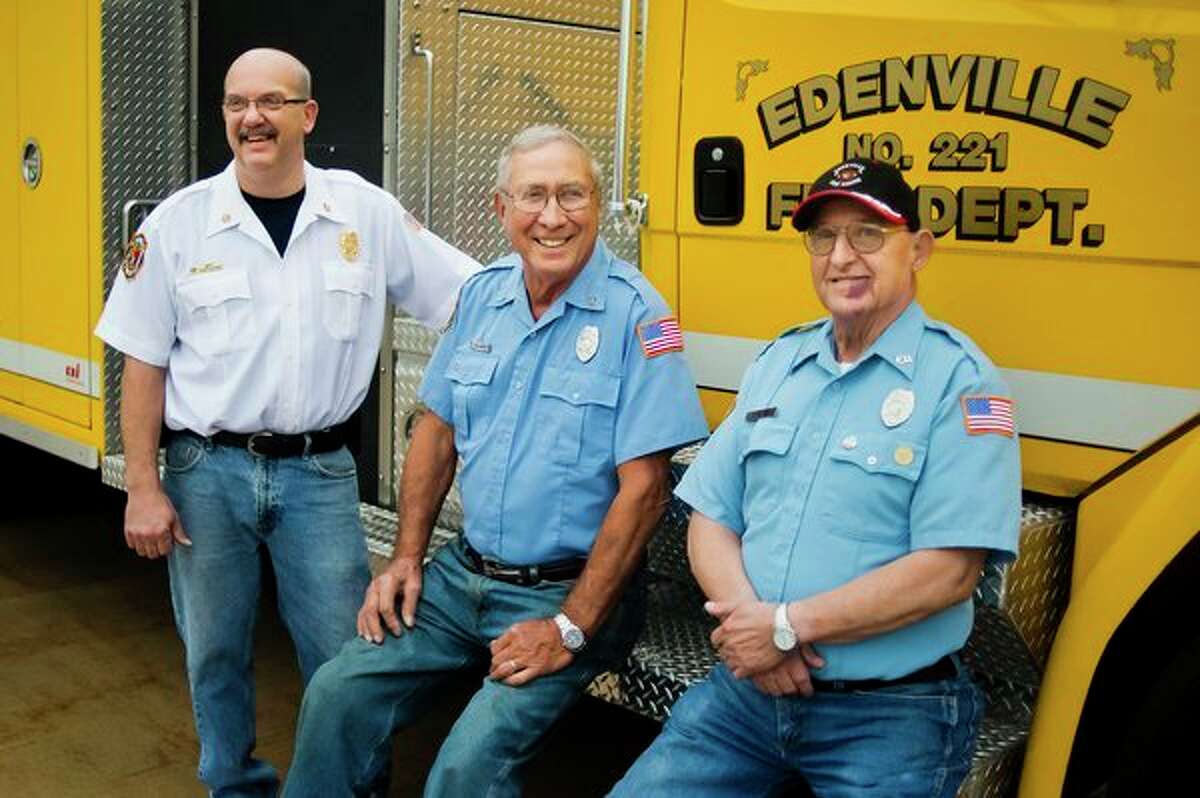 From left, Edenville Township Fire Chief Roger Dufresne, 53, volunteer firefighter Jim Vanderbush, 82, and volunteer firefighter Dick Bacon, 78, pose together for a portrait on Thursday at the Edenville Township Fire Station. Between the three of them, they have 135 years of service to the department. (Katy Kildee/kkildee@mdn.net)