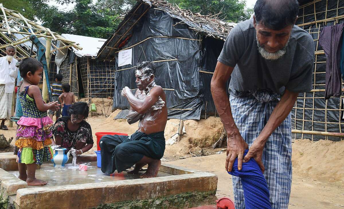 A Rohingya Muslim refugee takes bath at the Balukhali refugee camp in Bangladesh's Ukhia district on November 4, 2017. More than 600,000 Rohingya have fled to Bangladesh since late August carrying accounts of murder, rape and arson at the hands of Myanmar's powerful army during a military crackdown dubbed as "ethnic cleansing" by the UN. / AFP PHOTO / Dibyangshu SARKARDIBYANGSHU SARKAR/AFP/Getty Images