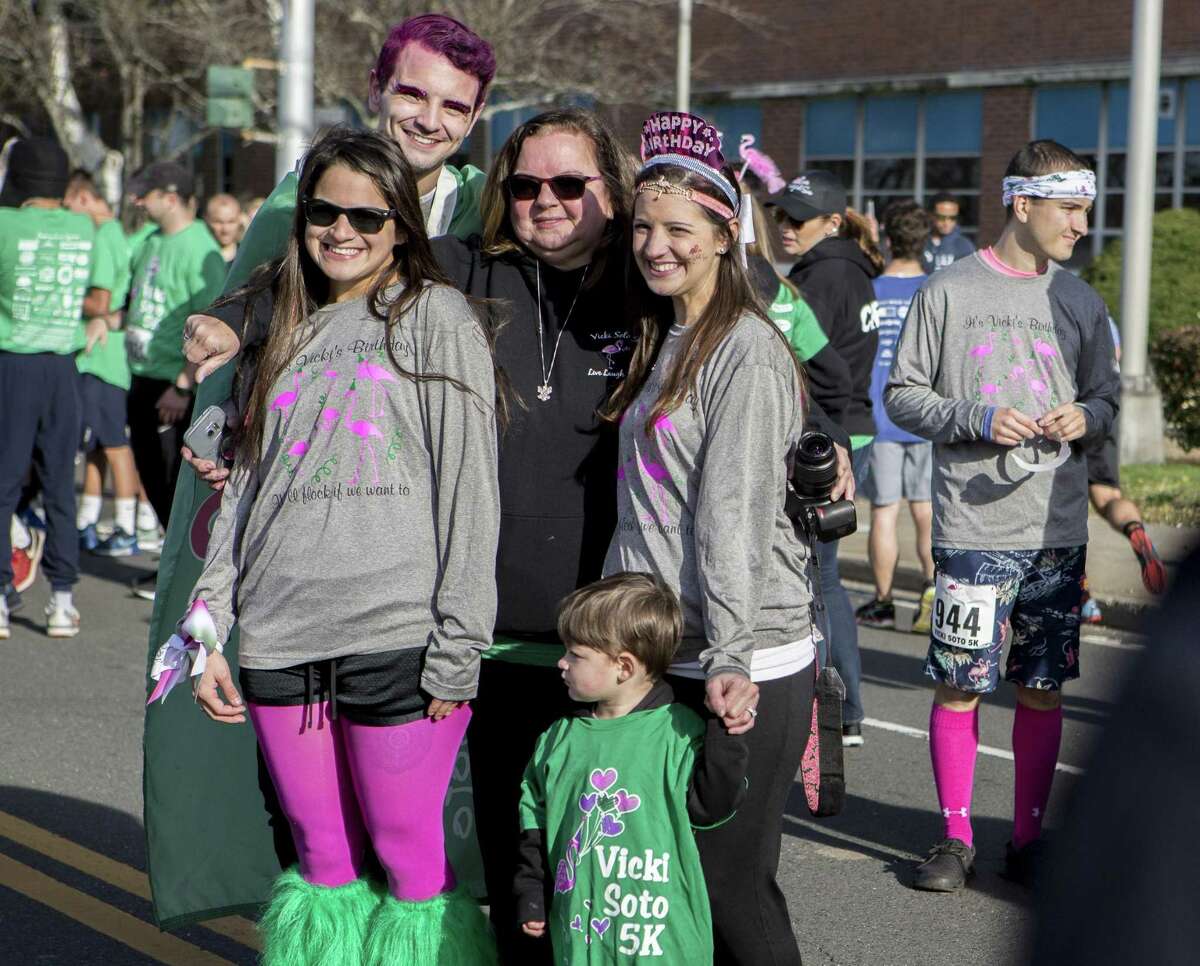 The family of Vicki Soto, sister Carlee Soto-Parisi, brother Matthew Soto, mother Donna Soto, sister Jillian Soto and nephew Kyllian Parisi, pose for a photo before the 5th annual Vicki Soto 5k run/walk in Stratford, Conn. on Saturday, Nov. 4, 2017. The event is held to honor slain Sandy Hook teacher Vicki Soto and raise money for the Vicki Soto Memorial Fund which supports vital educational initiatives and literacy needs of the community.