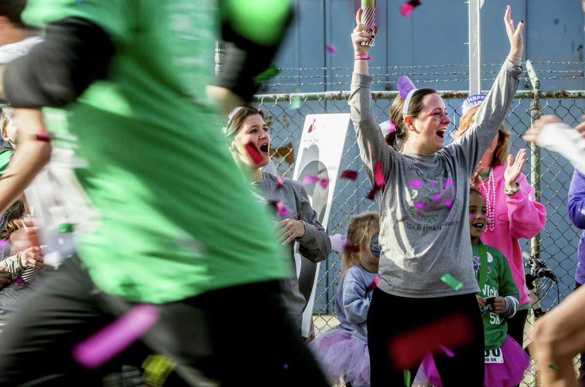 Heather Cronk, right and Brianne Cronk, left, cheer on runners at the 5th annual Vicki Soto 5k run/walk in Stratford, Conn. on Saturday, Nov. 4, 2017. The roadrace is held to honor slain Sandy Hook teacher Vicki Soto and raise money for the Vicki Soto Memorial Fund which supports vital educational initiatives and literacy needs of the community.