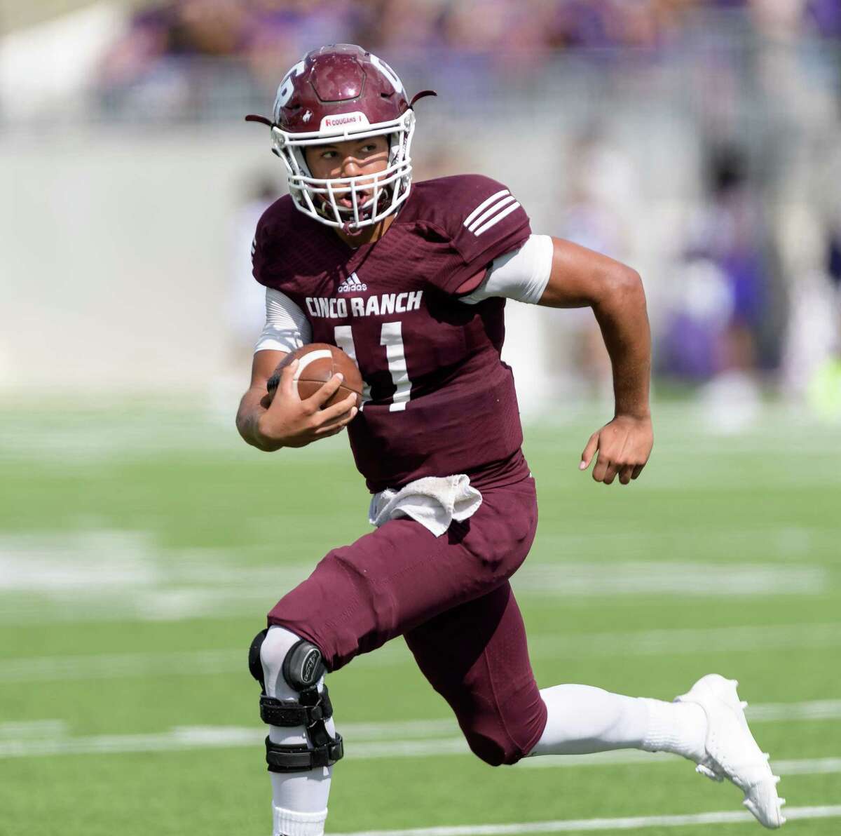 Cam Harper (11) of the Cinco Ranch Cougars runs around right end in the second half against the Morton Ranch Mavericks in a high school football game on Saturday, November 4, 2017 at Legacy Stadium in Katy Texas.