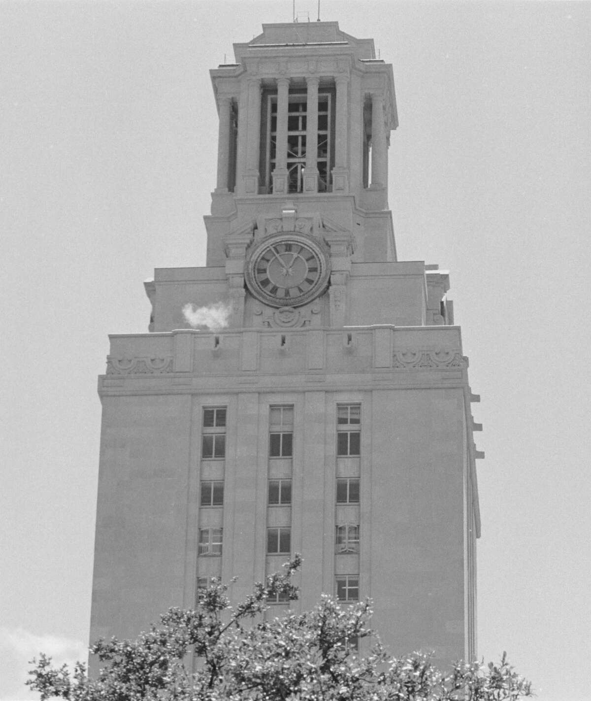 A puff of smoke is visible from the University of Texas Tower during a sniping siege on Aug. 1, 1966, by gunman Charles Whitman, who killed 17 people.
