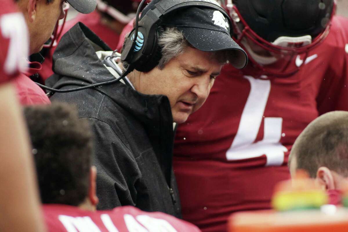 Washington State head coach Mike Leach, center, speaks with his players during the first half of an NCAA college football game against Stanford in Pullman, Wash., Saturday, Nov. 4, 2017. (AP Photo/Young Kwak)