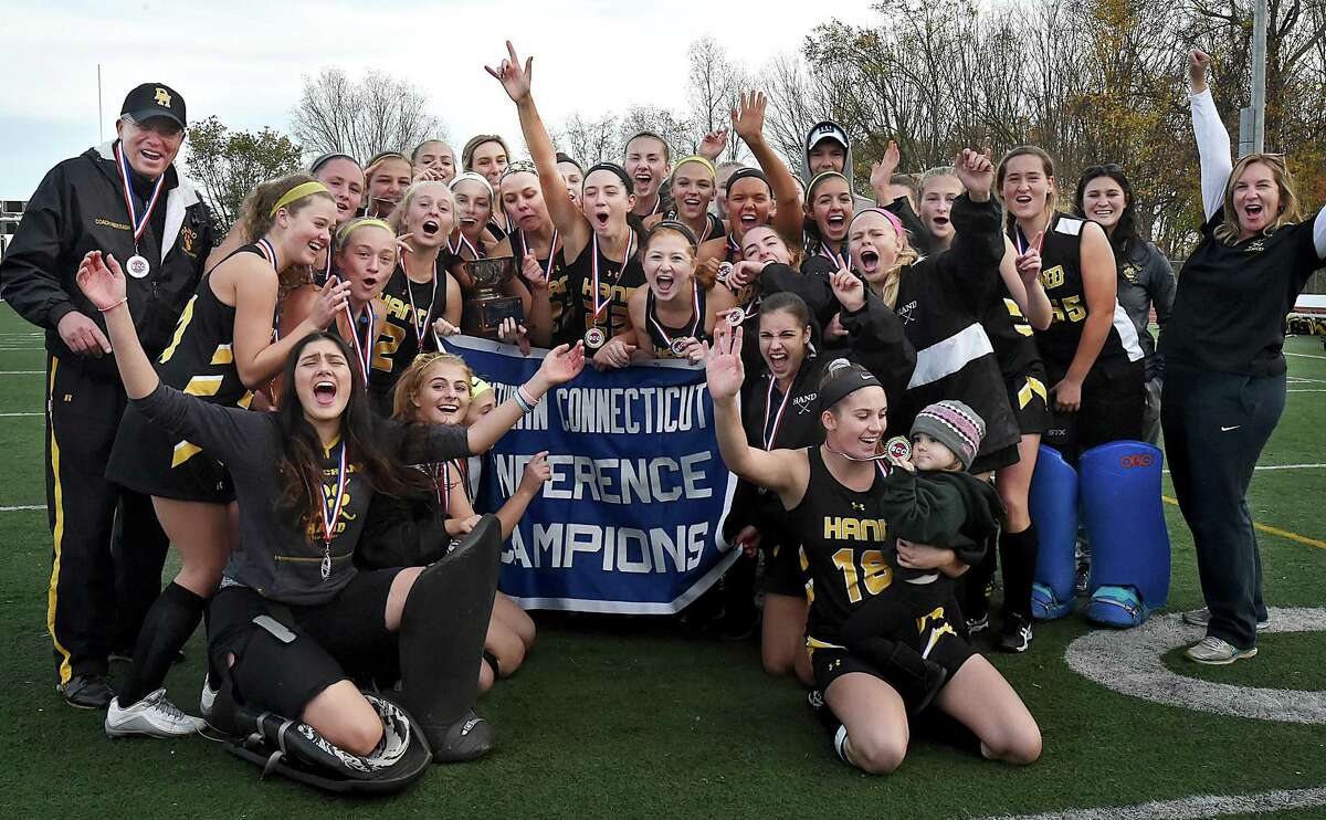 Members of the Hand field hockey team celebrate their victory over Branford in the SCC championship game Saturday in Guilford.