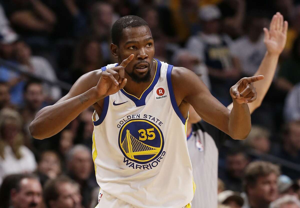 Golden State Warriors forward Kevin Durant celebrates after hitting a three-point basket against the Denver Nuggets during the third quarter of an NBA basketball game Saturday, Nov. 4, 2017, in Denver. (Photo by Jack Dempsey)